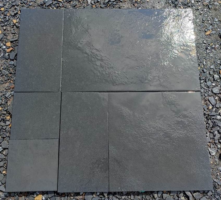 Kota Black limestone paving slabs on ground wet