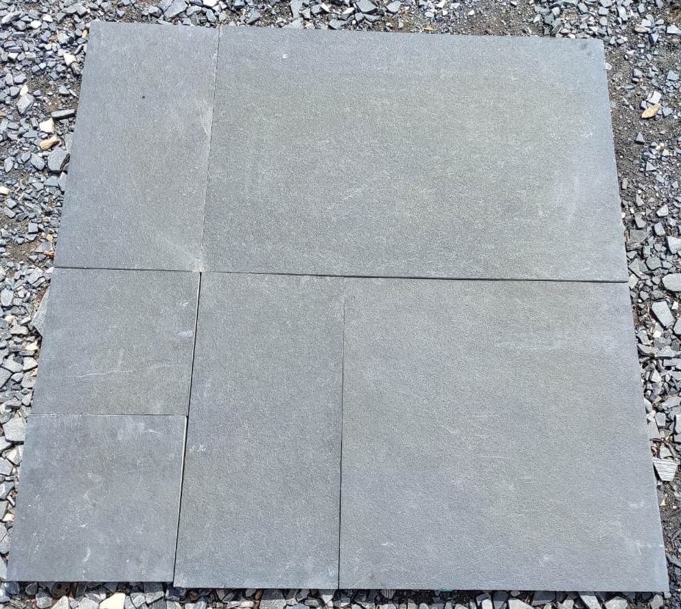 Kota Black limestone paving slabs on ground dry