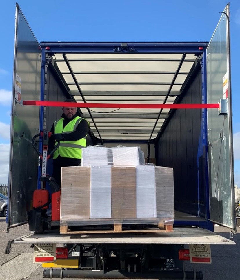 Man delivering pallet from tail lift truck