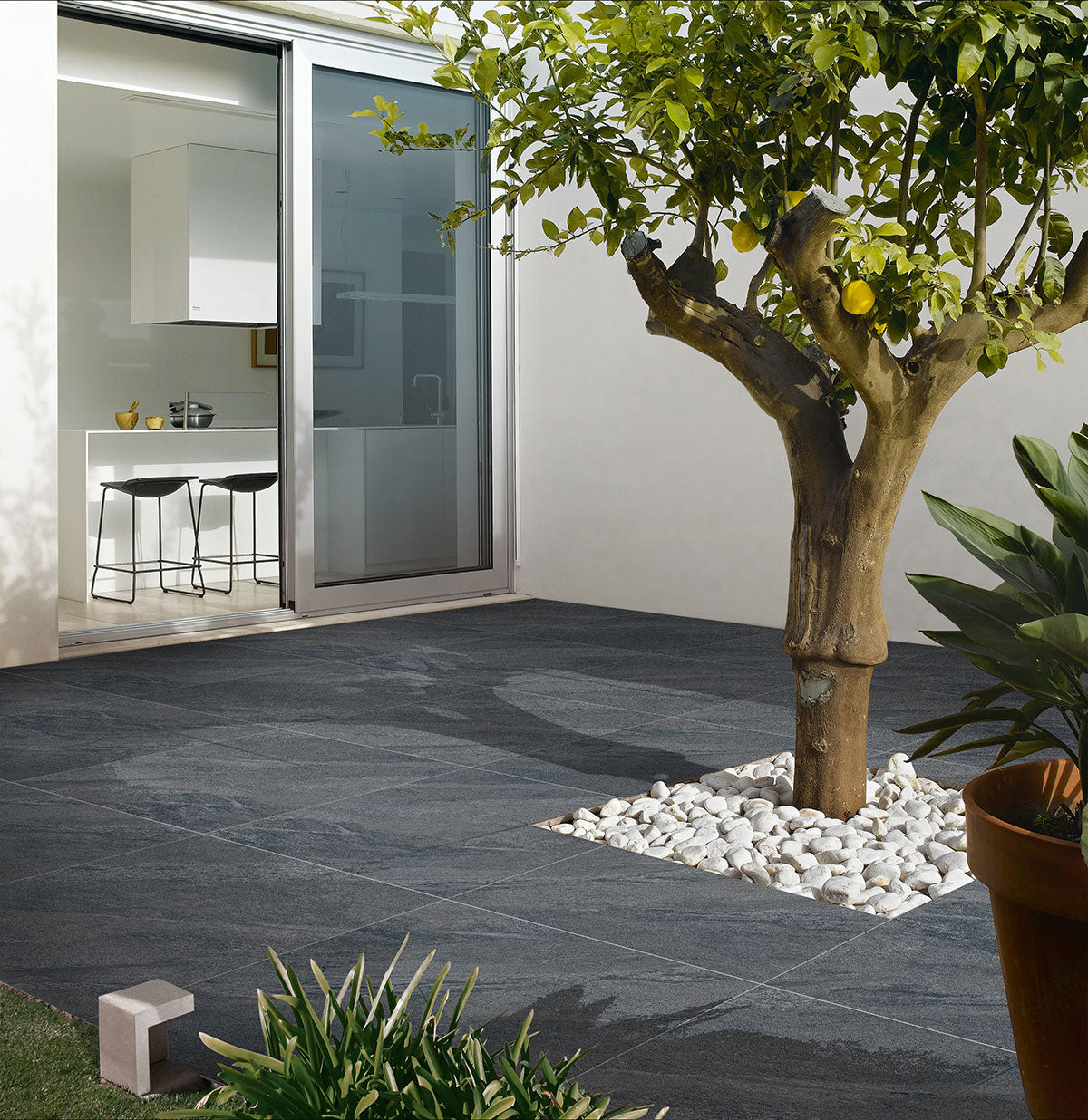 County Anthracite porcelain paving slabs on patio with tree