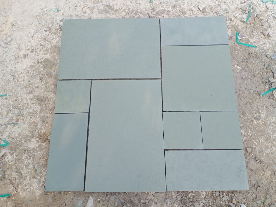 Kota Blue limestone paving slabs on ground wet