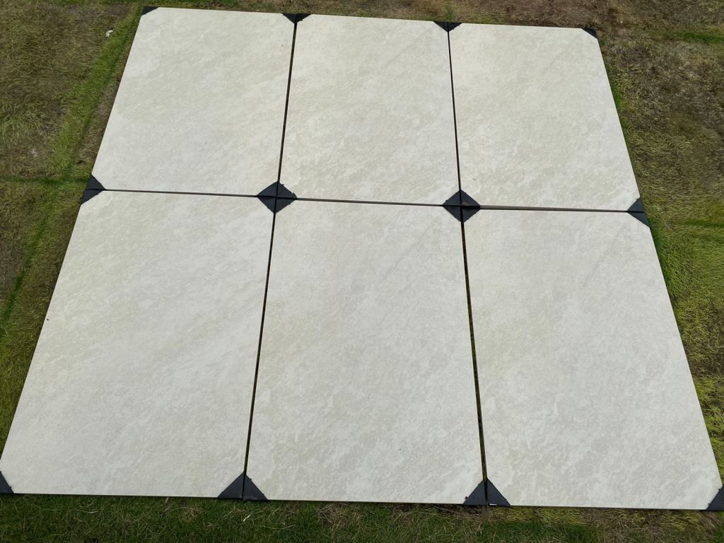 Quartz White porcelain paving slabs on grass