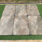 Rough Bruno porcelain paving slabs on grass