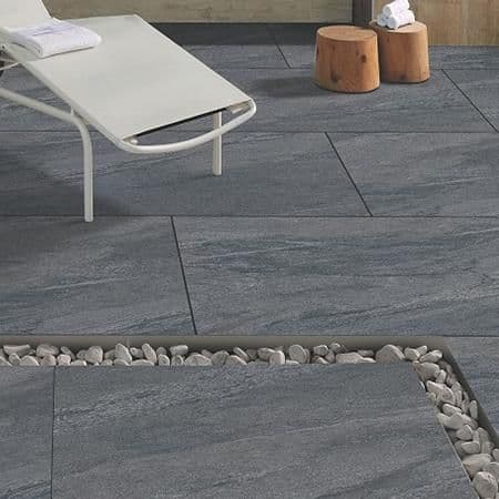 County Anthracite porcelain paving slabs on patio with sun lounger