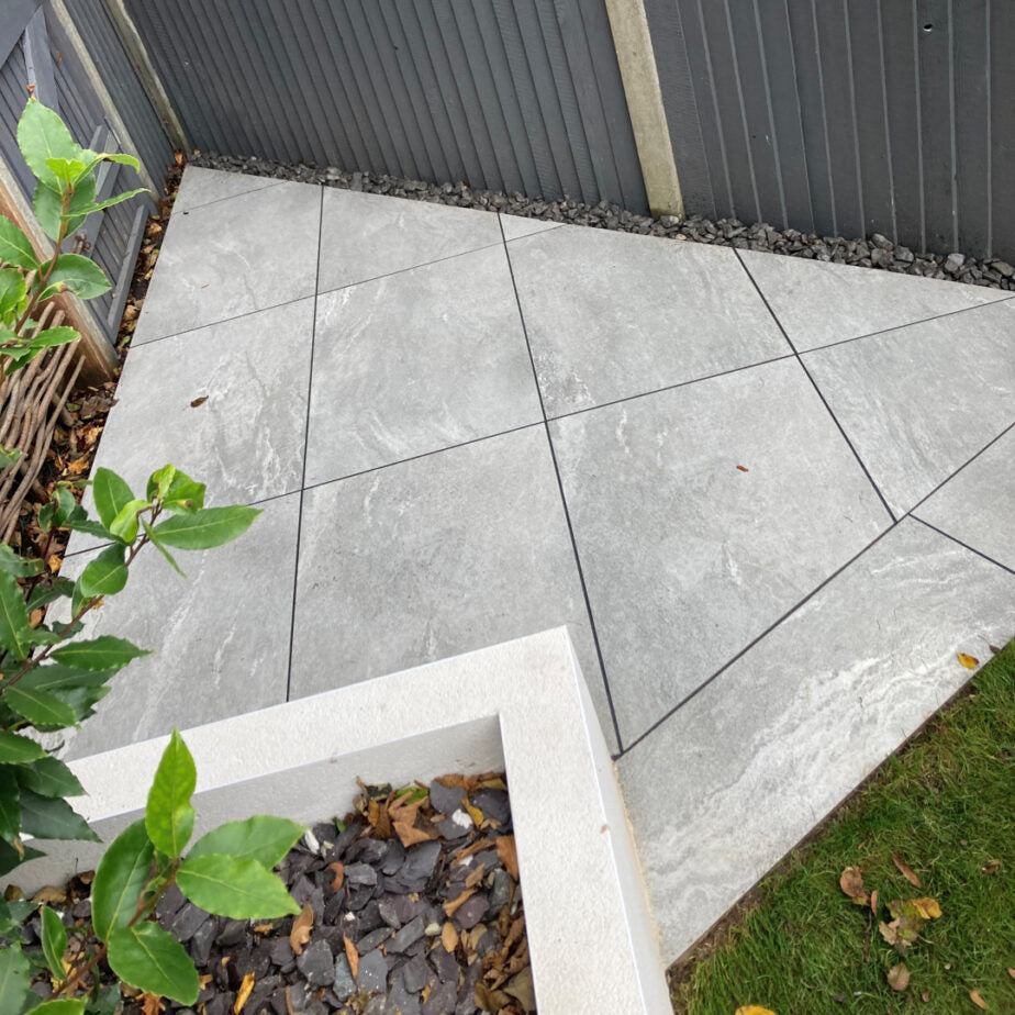 Earthcore Grey porcelain paving slabs in garden corner