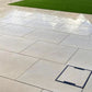 Hammerstone Beige porcelain paving slabs on wet patio