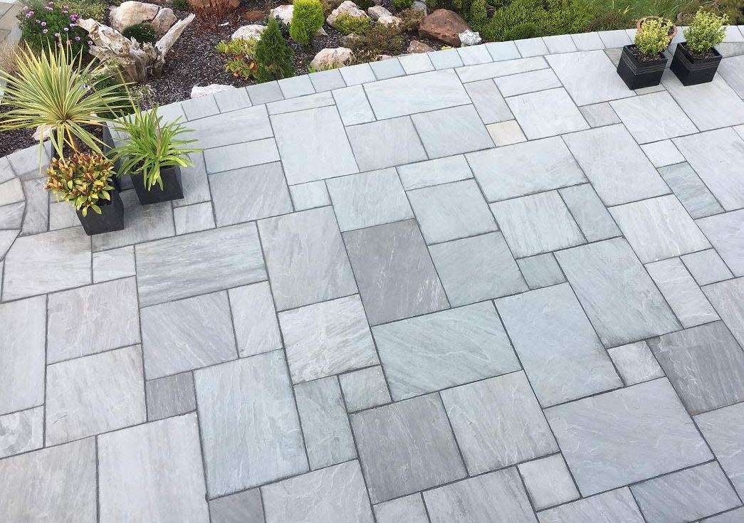 Kandla Grey Sandstone Paving Slabs in mixed sizes by rockery