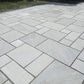 Kandla Grey sandstone paving slabs in mixed sizes on patio