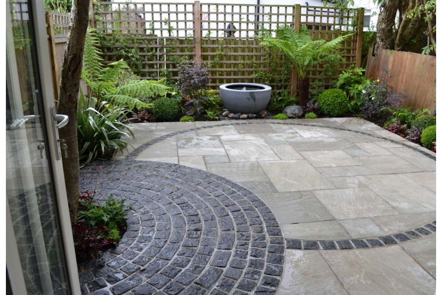 Galaxy Black granite cobbles in circle pattern on patio