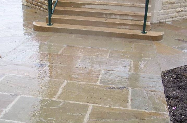 Raj Green sandstone paving slabs by steps wet